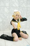 blonde_hair cosplay default_costume detached_sleeves hairbow headset kagamine_rin leg_warmers shorts vocaloid yuuhi rating:Safe score:0 user:nil!
