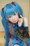 blouse cosplay detached_sleeves hatsune_miku headset kii_anzu pleated_skirt skirt twintails vocaloid rating:Safe score:0 user:nil!