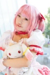 bows choker cosplay dress gloves hairbow kaname_madoka kujyou_konegi pink_hair plushie puella_magi_madoka_magica red_eyes tiered_skirt twintails rating:Safe score:0 user:pixymisa