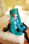 aqua_hair arai_yomi bed blouse cosplay detached_sleeves hatsune_miku headset pleated_skirt skirt thighhighs tie twintails vocaloid rating:Safe score:0 user:nil!