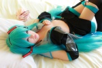 aqua_hair arai_yomi bed blouse cleavage cosplay detached_sleeves hatsune_miku headset open_clothes panties pleated_skirt skirt thighhighs tie twintails vocaloid rating:Safe score:2 user:nil!