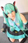 aqua_hair cosplay default_costume detached_sleeves hatsune_miku headset pleated_skirt skirt tenko thighhighs tie twintails vocaloid zettai_ryouiki rating:Safe score:0 user:nil!