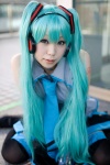 aiko aqua_hair cosplay default_costume detached_sleeves hatsune_miku headset pleated_skirt skirt thighhighs tie twintails vocaloid zettai_ryouiki rating:Safe score:0 user:nil!