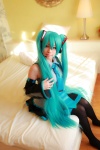 aqua_hair arai_yomi bed blouse cosplay detached_sleeves hatsune_miku headset pleated_skirt skirt thighhighs tie twintails vocaloid rating:Safe score:0 user:nil!