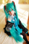 aqua_hair arai_yomi bed blouse cosplay detached_sleeves hatsune_miku headset pleated_skirt skirt thighhighs tie twintails vocaloid rating:Safe score:0 user:nil!