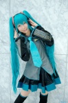 aqua_hair blouse cosplay detached_sleeves hatsune_miku headset kei pleated_skirt skirt thighhighs tie twintails vocaloid zettai_ryouiki rating:Safe score:0 user:nil!