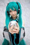 aqua_hair blouse cosplay detached_sleeves hatsune_miku headset microphone mineo_kana pleated_skirt skirt tie twintails vocaloid rating:Safe score:0 user:nil!