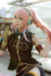 boots cosplay detached_sleeves headset megurine_luka pink_hair pom_poms skirt sleeveless_blouse thighhighs vocaloid yuu rating:Safe score:2 user:nil!