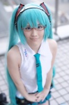aqua_hair cosplay glasses hatsune_miku headset pleated_skirt popuri skirt sleeveless_blouse thighhighs tie twintails vocaloid rating:Safe score:0 user:nil!