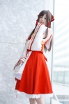 blouse cosplay detached_sleeves hairbow hakurei_reimu hino_(ii) miko miniskirt skirt touhou rating:Safe score:1 user:nil!
