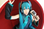 blouse blue_hair cosplay detached_sleeves haruka hatsune_miku headset microphone pleated_skirt skirt sleeveless_blouse twintails vocaloid rating:Safe score:0 user:nil!