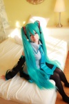 aqua_hair arai_yomi bed blouse cosplay detached_sleeves hatsune_miku headset pleated_skirt skirt thighhighs tie twintails vocaloid rating:Safe score:0 user:nil!