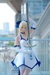 ageha blonde_hair blue_eyes choker cosplay dress elbow_gloves fate/series fate/stay_night gloves hairbow pointed_skirt saber skirt_train sword thighhighs zettai_ryouiki rating:Safe score:1 user:pixymisa