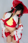 cosplay croptop detached_sleeves hairbow hakurei_reimu lenfried miko pleated_skirt skirt skirt_lift thighhighs touhou rating:Questionable score:0 user:nil!