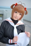 antenna_hair blouse cardcaptor_sakura cosplay hat karin_(iv) kinomoto_sakura sailor_uniform scarf_tie school_uniform twintails rating:Safe score:0 user:pixymisa